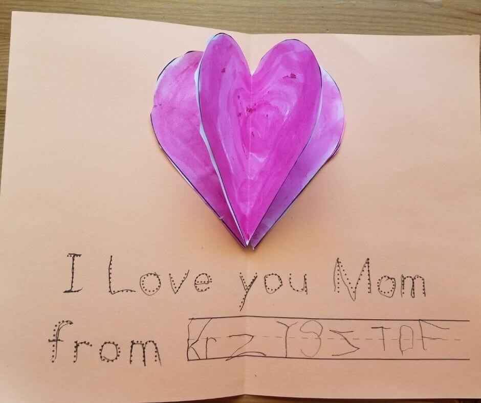 Mother's Day card with popup effect made by a kindergartener. Traceable wishes I love you, Mom.