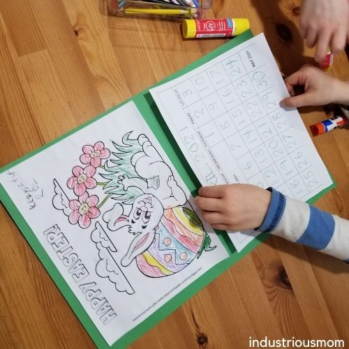 Kids making wall calendars. The page with a calendar has big traceable numbers with are easy to trace. 